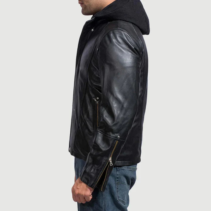 Person wearing a black leather jacket on a light gray background